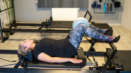 Person using a Pilates reformer machine in a physiotherapy at yorkville